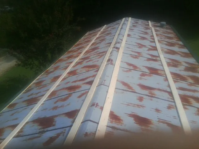Rusted metal roof panels with new wood purlins before replacement — Storm Damage Roof Repair in Madisonburg by Roofing Brothers