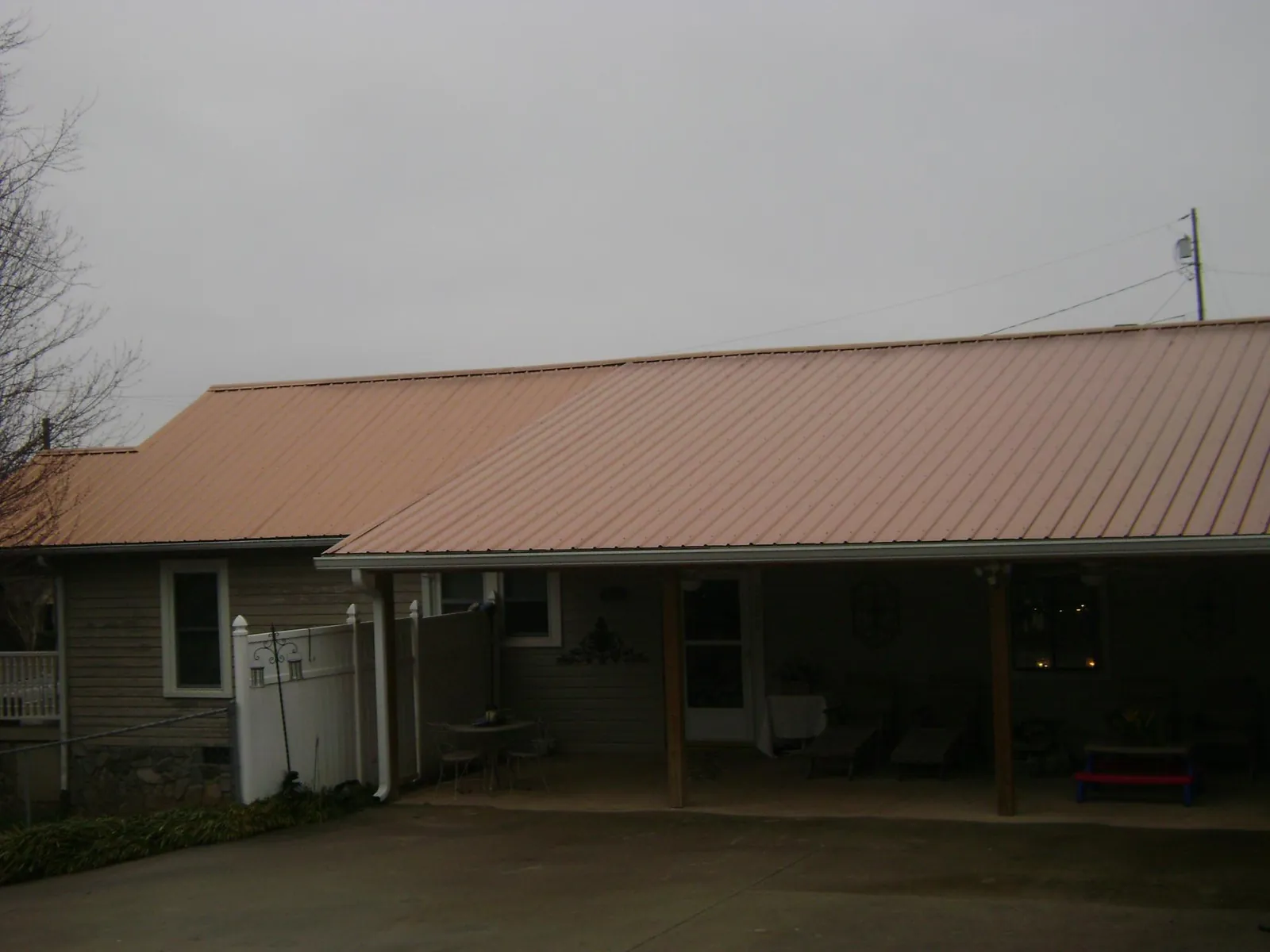 Copper toned metal roof over a wide covered patio in Madisonburg